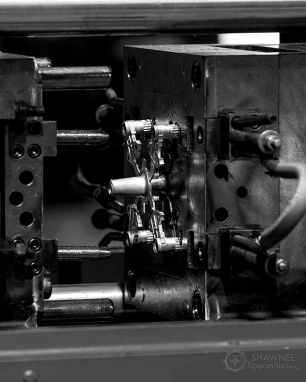 Precision part loaded in a die cast machine at Shawnee Specialties