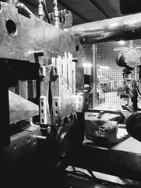 Aluminum part loaded in a die cast machine at Shawnee Specialties